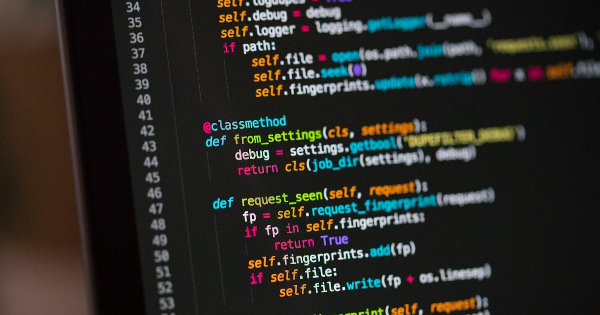 A close-up of a laptop screen displaying lines of code, representing the technical audit work at the center of this guide.